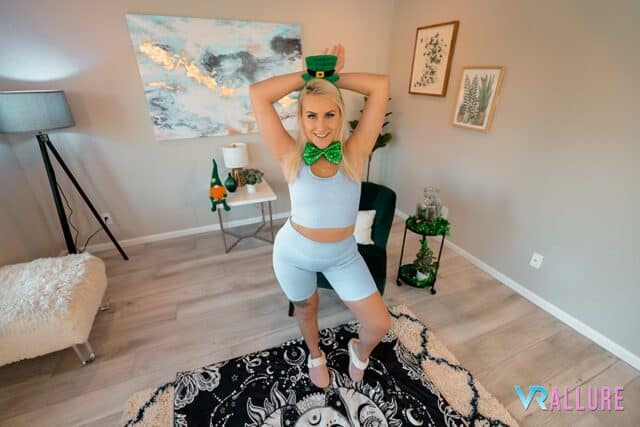 Indica Monroe XXXBios - Hot busty all natural thick blonde pornstar Indica Monroe shows off her big natural tits and big ass bubble butt booty in sexy blue vest top and blue booty shorts with white sneakers, green bow tie and green leprechaun hat - An Irish Lesson VR Allure Indica Monroe porn pics sfw - Indica Monroe VR porn scenes sfw pics