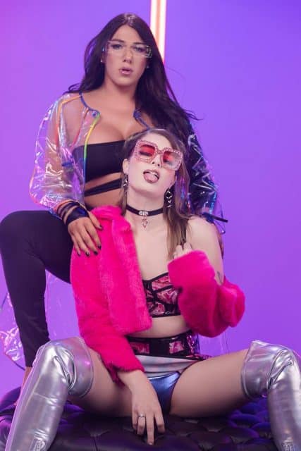 Asia Belle XXXBios - Hottest brunette big booty TS pornstar Asia Belle in sexy pink jacket, black choker, matching pink tie dye top and skirt with silver metallic thigh high platform boots alongside Aspen Brooks in black top, sheer PVC jacket, black pants and high heels - Strong Vitals Trans Angels Asia Belle porn pics sfw